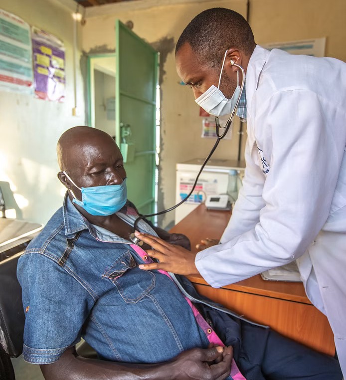 Doctor listens to a patient's heart in a health clinic