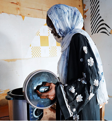 Woman uses an electric pressure cooker